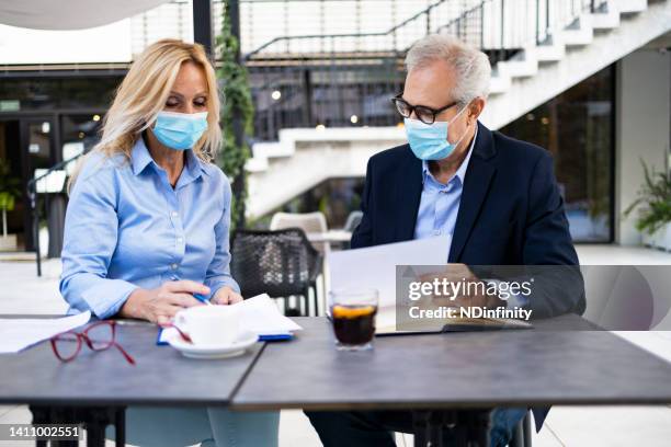 two senior businessmen considering a business plan and sign contract stock photo - business plan covid stock pictures, royalty-free photos & images