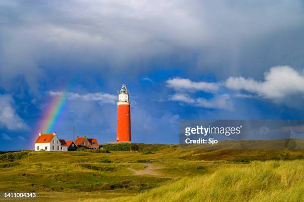 texel lighthouse in the dunes with a rainbow during a stormy autumn night - sjoerd van der wal or sjo imagens e fotografias de stock