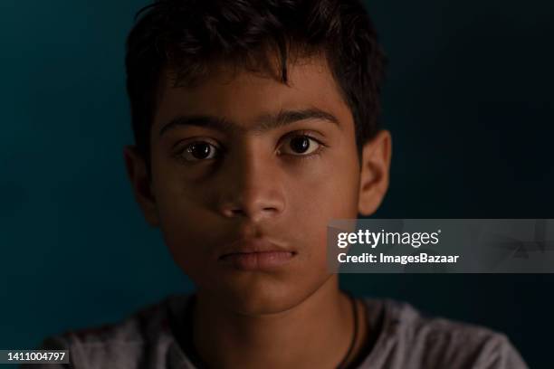 portrait of a boy looking sad - indian boy portrait stock pictures, royalty-free photos & images