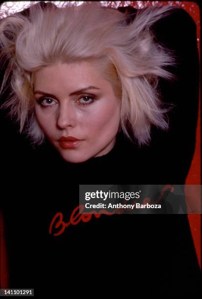 Portrait of American singer Debbie Harry, from the band Blondie, as she poses against a pink, vinyl backdrop, New York, New York, 1970s.