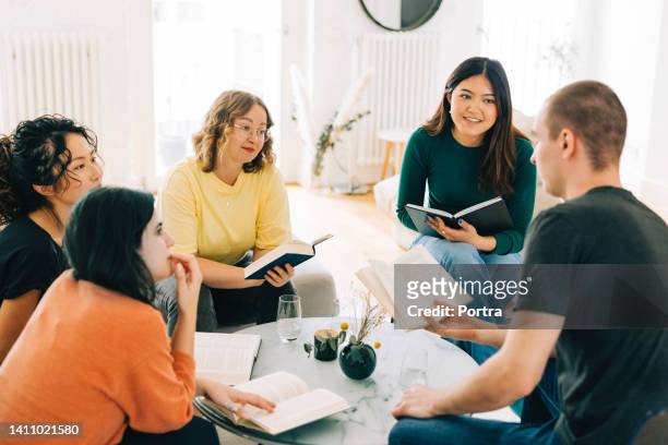 book club members discussing a book - russian literature stock pictures, royalty-free photos & images