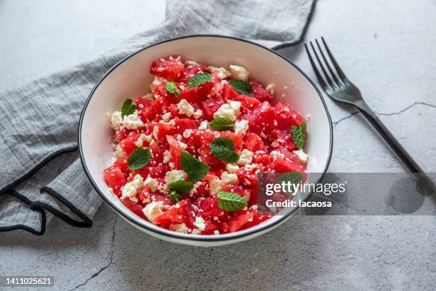 watermelon salad with feta and mint - feta stock-fotos und bilder