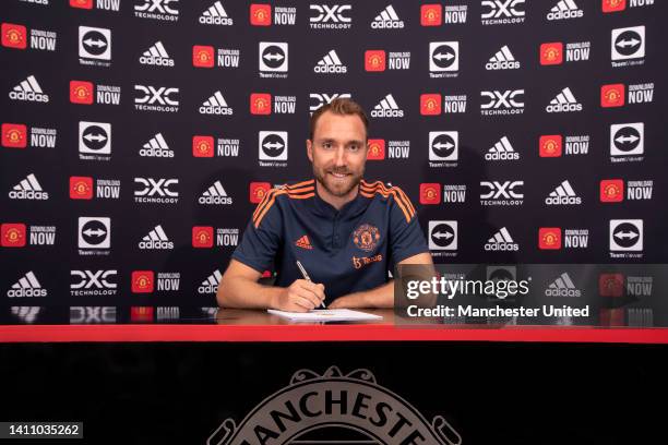 Christian Eriksen of Manchester United poses after signing for the club at Carrington Training Ground on July 26, 2022 in Manchester, England.