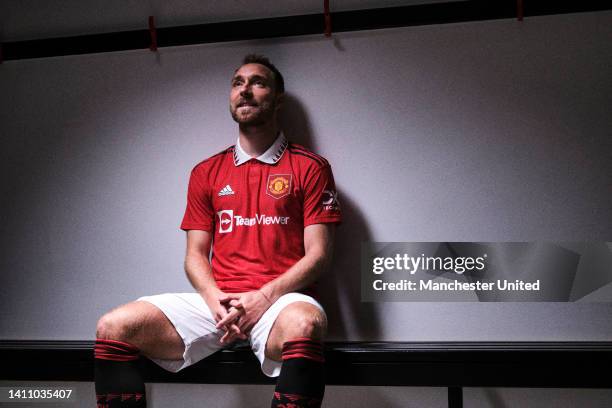 Christian Eriksen of Manchester United poses after signing for the club at Carrington Training Ground on July 26, 2022 in Manchester, England.