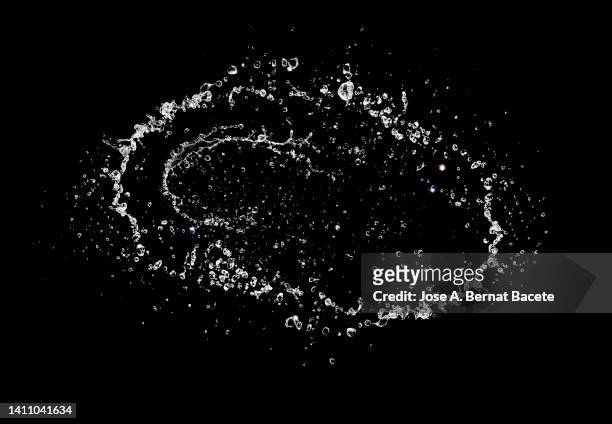 jets and splashes of water in circular motion on a black background. - raindrop stock-fotos und bilder