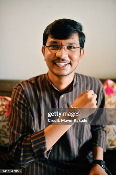 young man showing his rakhi - akhi stock pictures, royalty-free photos & images