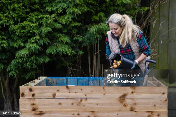 determined to make her own compost - compost bin people stock pictures, royalty-free photos & images