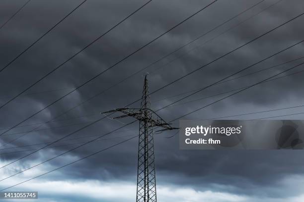 electricity pylon with dark clouds - power cut stock pictures, royalty-free photos & images