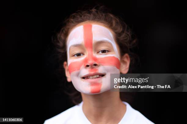 An England fan with their countries flag painted on their face looks on prior to the UEFA Women's Euro 2022 Semi Final match between England and...