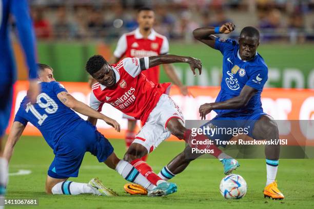 Thomas Partey of Arsenal holds of the defending Malang Sarr of Chelsea and Mason Mount of Chelsea during a game between Arsenal FC and Chelsea FC at...
