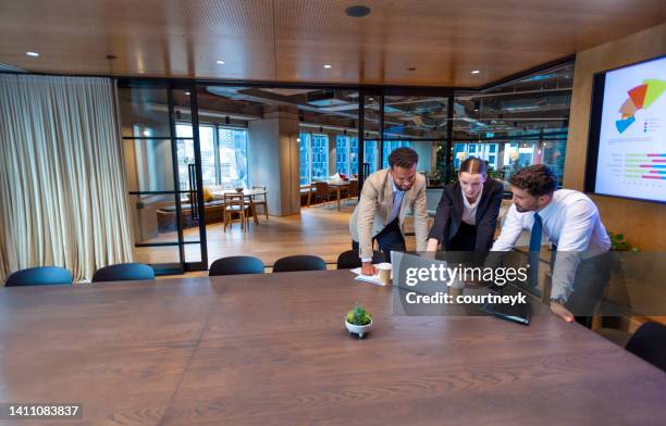 business people working on a laptop computer in a modern office - financial result stockfoto's en -beelden