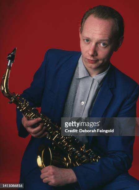 Deborah Feingold/Corbis via Getty Images) Portrait of English Pop, Jazz, and New Wave musician Joe Jackson as he poses with his saxophone, New York,...