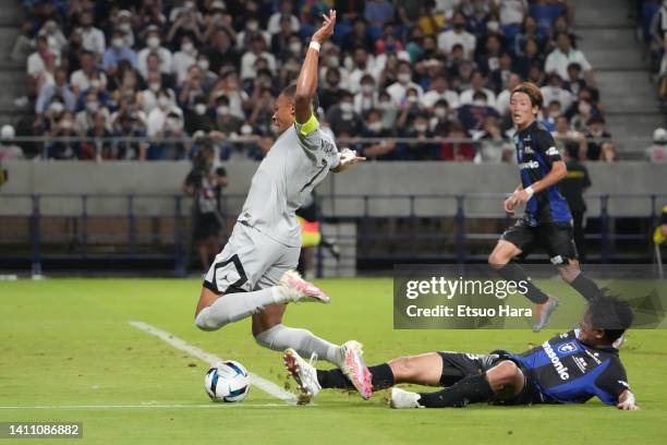 Kylian Mbappe of Paris Saint-Germain is tackled by Ryu Takao of Gamba Osaka during the preseason friendly between Paris Saint-Germain and Gamba Osaka...