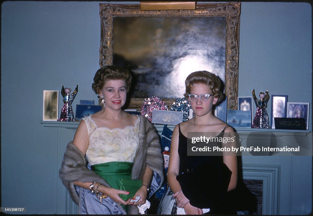 Mother and daughter in front of fireplace mantle