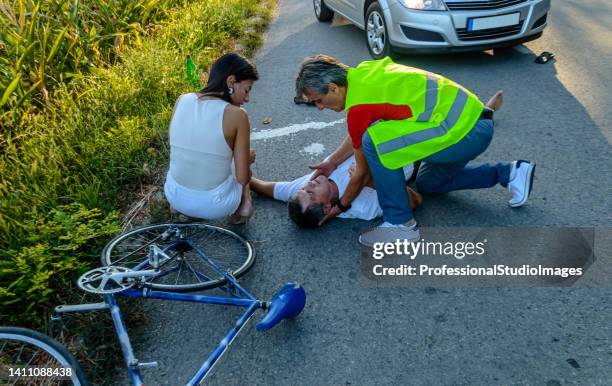 photo of accident in traffic and young man fell from a bike. - casualty stock pictures, royalty-free photos & images