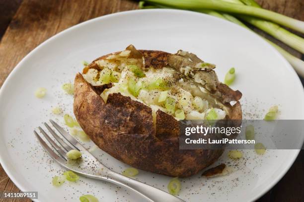 baked potato with melted butter - stuffed potato stock pictures, royalty-free photos & images