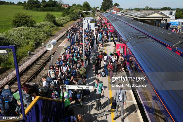 People arrive by train at Castle Cary railway station at the 2015 Glastonbury Festival held at Worthy Farm, in Pilton, Somerset on June 24, 2015 near...