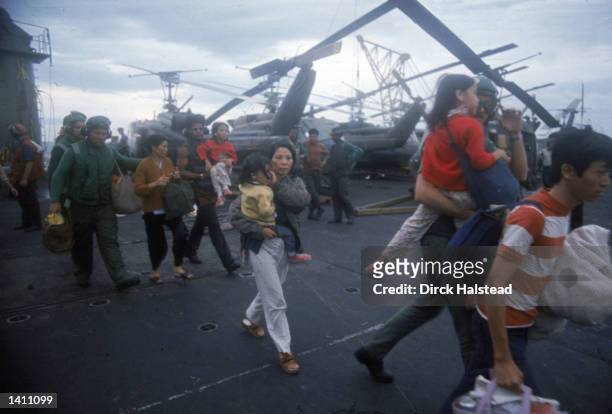 South Vietnamese refugees board a U.S. War ship April 1975 in the South China Sea near Saigon. American involvement in the Vietnam War came to an end...