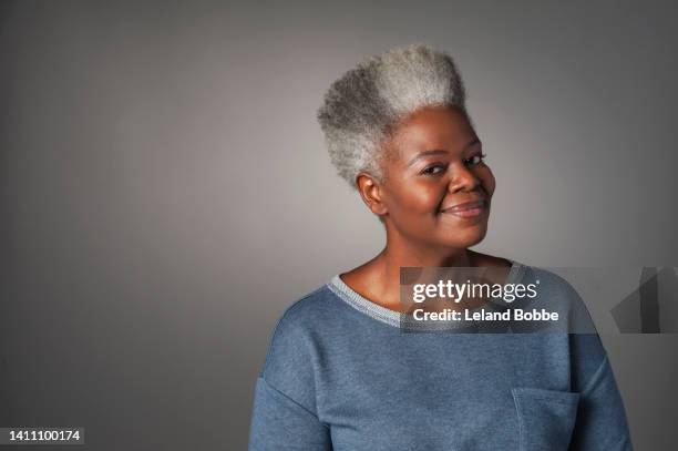 studio portrait of middle aged african american woman - 40s woman t shirt studio stock pictures, royalty-free photos & images