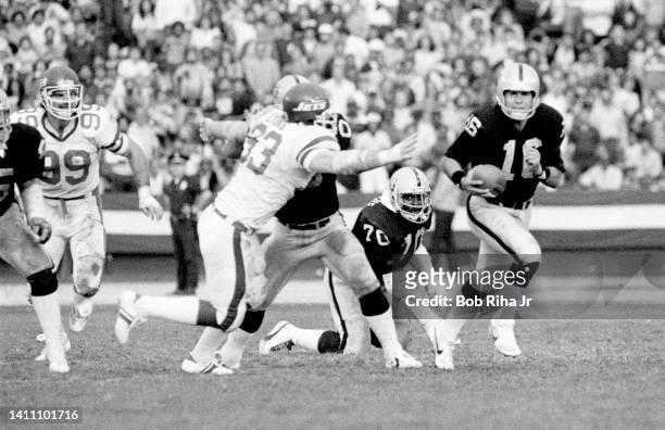 Raiders QB Jim Plunkett is pursued by NY Jets players during AFC Playoff game, January 15, 1983 in Los Angeles, California.
