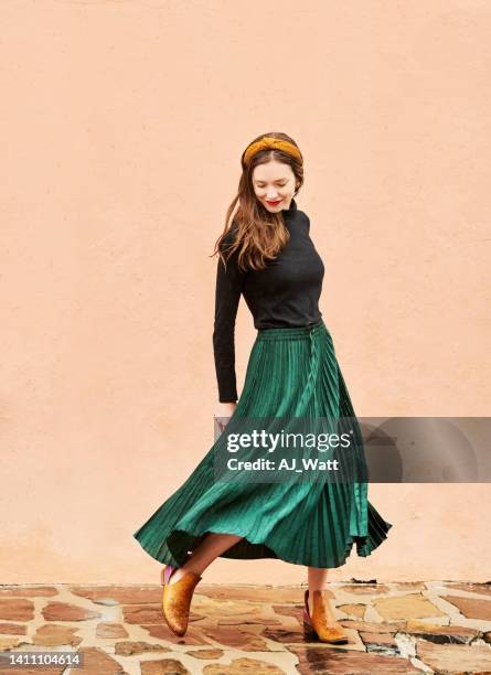 stylish young woman walking outside - long skirt stock pictures, royalty-free photos & images