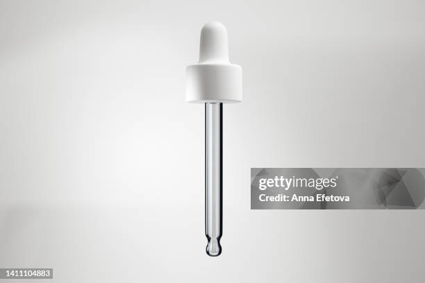 glass pipette with white dropper - pipette stock-fotos und bilder