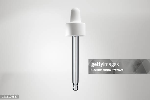 glass pipette with white dropper - ピペット ストックフォトと画像