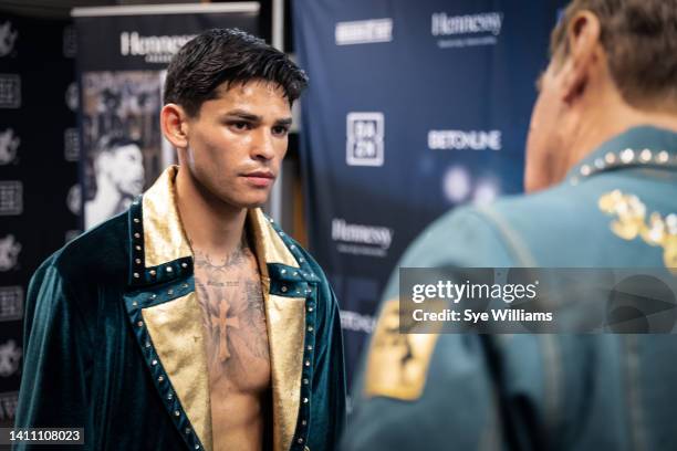 Ryan Garcia speaks with his coach Joe Goossen before his lightweight fight against Emmanuel Tagoe at Alamodome April 9, 2022 in San Antonio, Texas.