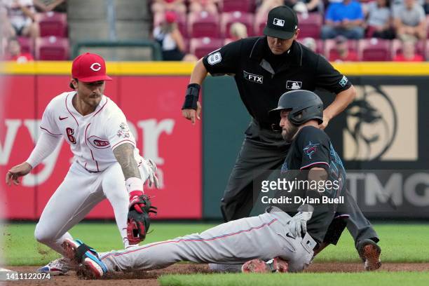 Jonathan India of the Cincinnati Reds tags out Jacob Stallings of the Miami Marlins at second base in the third inning at Great American Ball Park on...