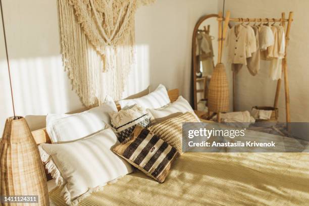 boho pillows on bed  in bedroom. - estilo boho fotografías e imágenes de stock