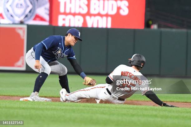 Yu Chang of the Tampa Bay Rays tags out Adley Rutschman of the Baltimore Orioles on a fielder choice in the second inning during a baseball game at...