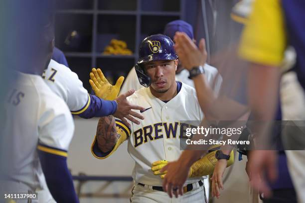 Kolten Wong of the Milwaukee Brewers is congratulated by teammates following a home run during the fifth inning against the Minnesota Twins at...
