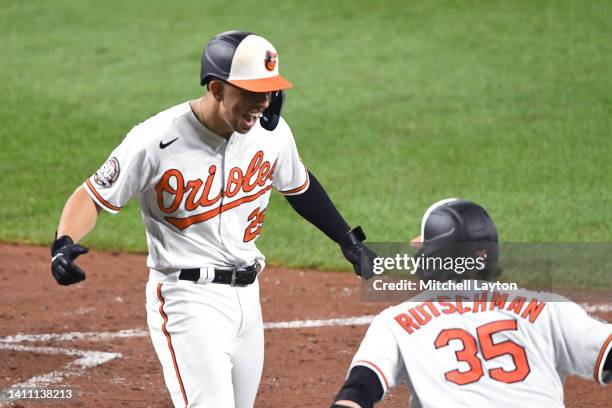 Ramon Urias of the Baltimore Orioles celebrates a two run home run in the eight inning with Adley Tutschman during a baseball game against the Tampa...