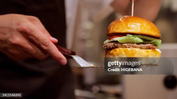 japanese men are making hamburgers. - teppanyaki stock pictures, royalty-free photos & images