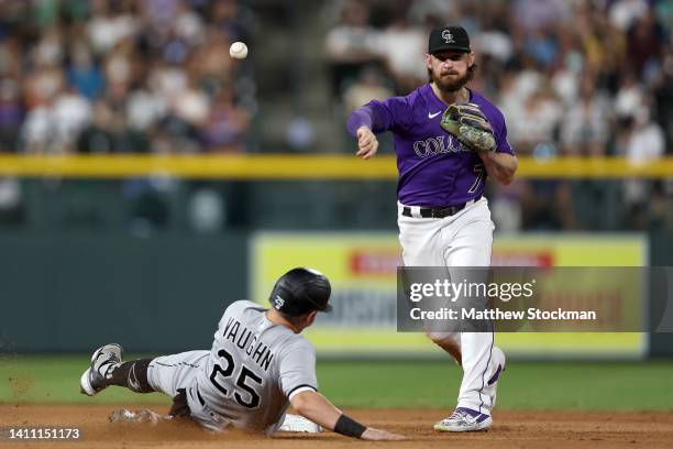 Brendan Rodgers of the Colorado Rockies turns the first half of a double play against Andrew Vaughn of the Chicago White Sox in the seventh inning at...