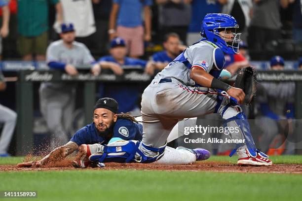 Crawford of the Seattle Mariners scores against Meibrys Viloria of the Texas Rangers to tie the game in the ninth inning at T-Mobile Park on July 26,...