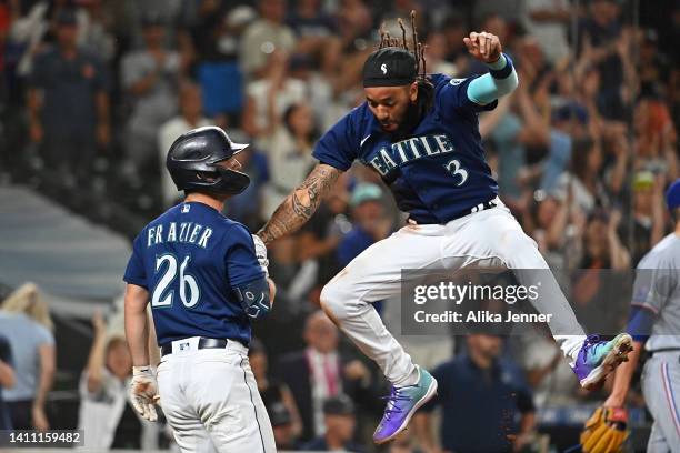 Crawford of the Seattle Mariners celebrates scoring to tie the game with Adam Frazier in the ninth inning against the Texas Rangers at T-Mobile Park...