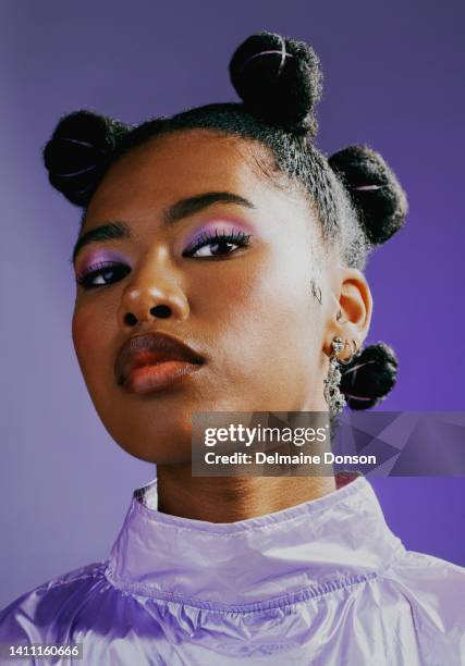 confident female with bold personality and cool attitude. portrait of an edgy young woman wearing fashionable purple makeup and clothes with a trendy hairstyle against a vibrant studio background. - beautiful black hair stock pictures, royalty-free photos & images