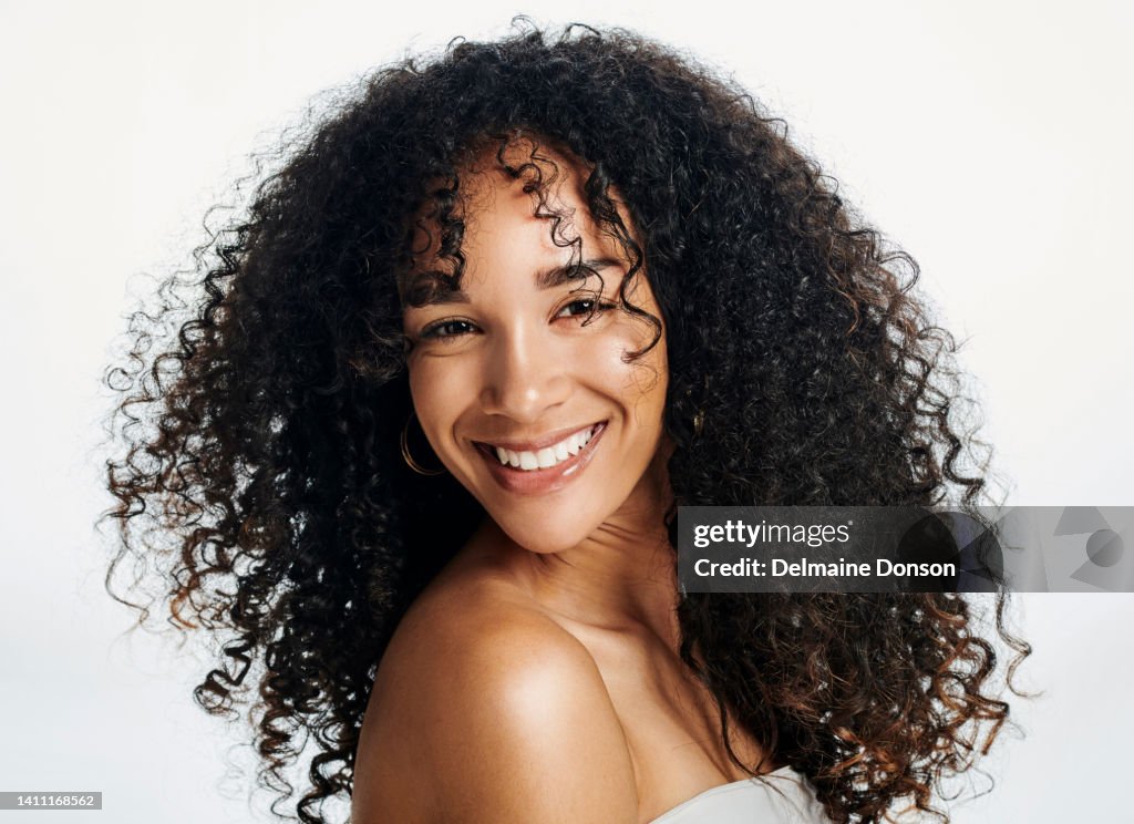 Portrait Of A Beauty African Woman With Natural Curly Hair And Perfect Skin  Against A Isolated White Background Black Female Feeling Satisfied With  Facial Treatment And Results Of Skincare Routine High-Res Stock