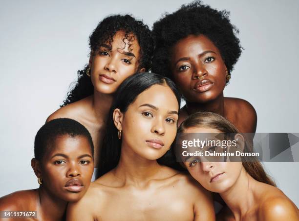 beauty portrait of a diverse group of beautiful women posing together against a grey studio background. faces of female models with perfect, clear skin and complexion from a daily skincare routine - organised group photo stock pictures, royalty-free photos & images