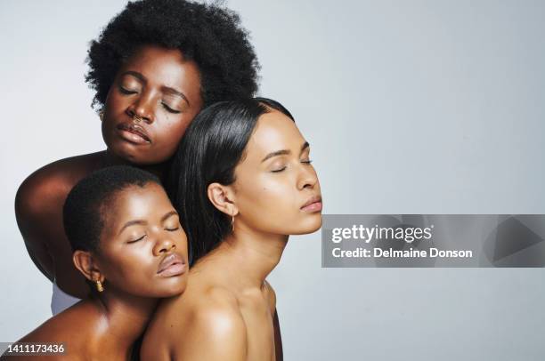 three diverse and sensual beauty women feeling confident and comfortable in their skin. different females with beautiful faces and good skincare, standing against grey background with copyspace - black makeup stockfoto's en -beelden