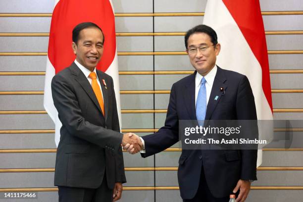 Indonesian President Joko Widodo and Japanese Prime Minister Fumio Kishida shake hands prior to their meeting at the prime minister's office on July...