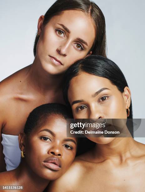 portrait of diverse and beautiful young women with glowing skin, natural beauty and flawless complexion posing on a grey studio background. group of confident and empowered multiethnic females - perfect complexion stock pictures, royalty-free photos & images