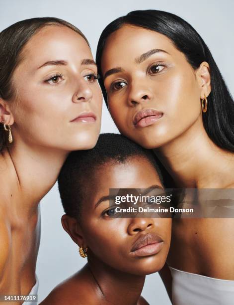 portrait of a diverse group of beauty campaign models posing against white studio background. gorgeous female models showing their clear skin and complexion from a skincare routine and huddling - perfect complexion stock pictures, royalty-free photos & images