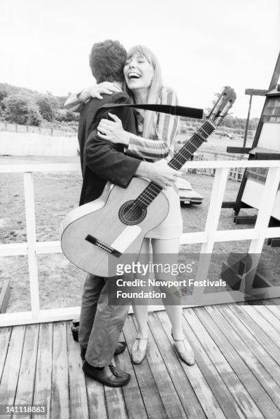 Singer-songwriters Leonard Cohen and Joni Mitchell meet backstage before their separate performances at the Newport Folk Festival at Newport, Rhode...