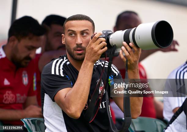 Cenk Tosun of Besiktas takes a photographer camera prior to the pre-season friendly match between Besiktas and Alaves at Estadio Camilo Cano on July...