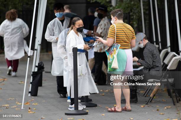 People wait to recieve the Monkeypox vaccine at a mass vaccination site in Manhattan on July 26, 2022 in New York City.