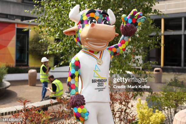 Worker are seen on a break near a Perry the Bull mascot at the NEC as the arenas are prepared ahead of the Birmingham 2022 Commonwealth Games at the...