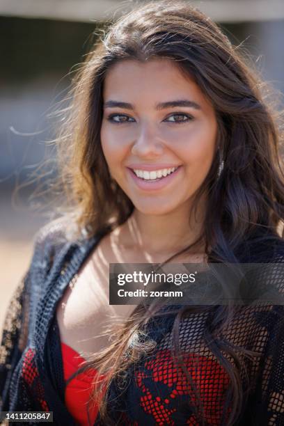 beautiful young brunette smiling happily at camera - female décolletage stock pictures, royalty-free photos & images