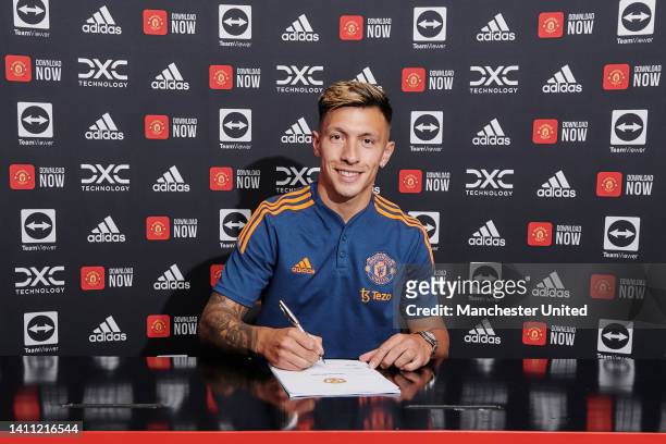 Lisandro Martinez of Manchester United poses after signing for the club at Carrington Training Ground on July 26, 2022 in Manchester, England.